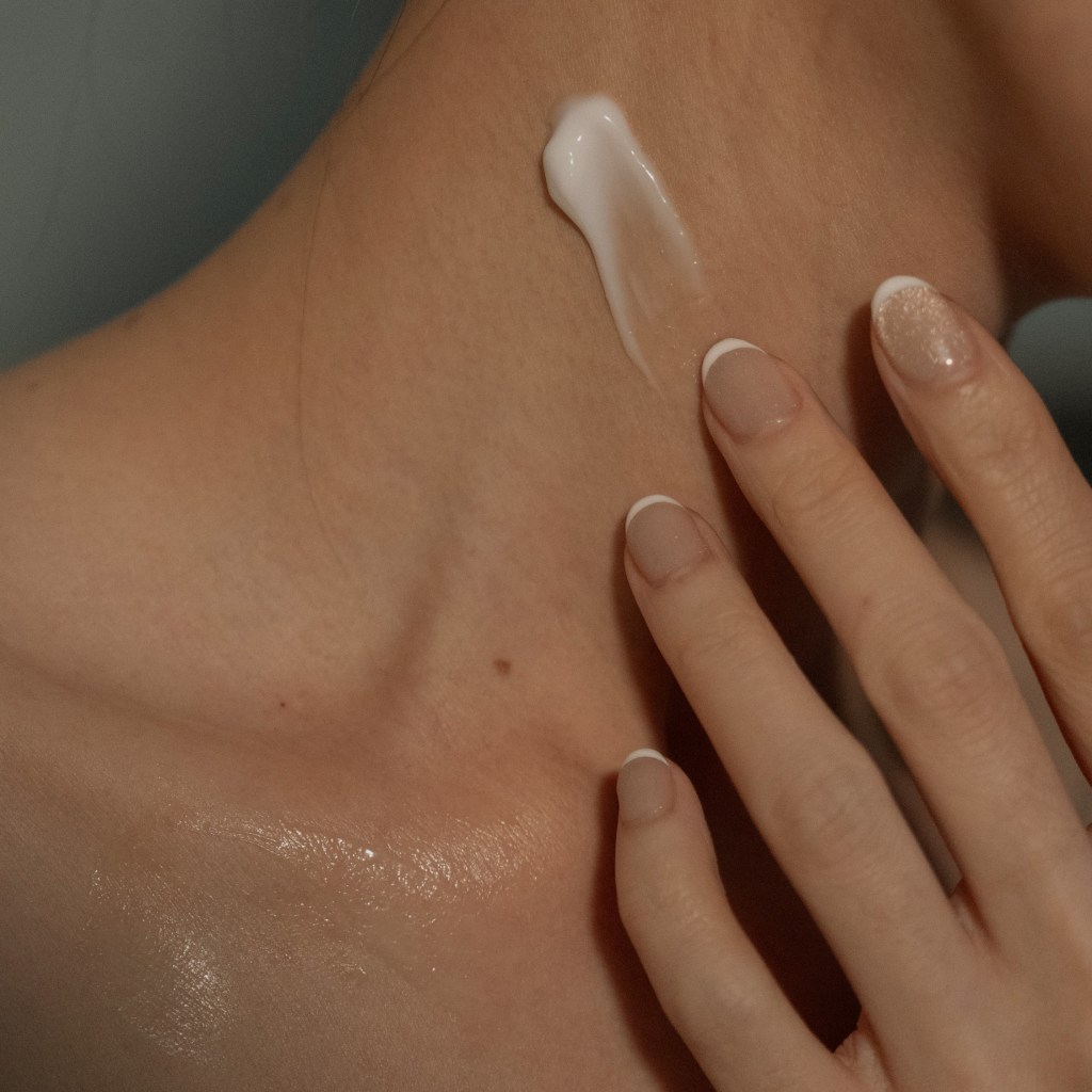 Close-up of lightweight body cream swatch being applied to the neck for post-workout hydration.